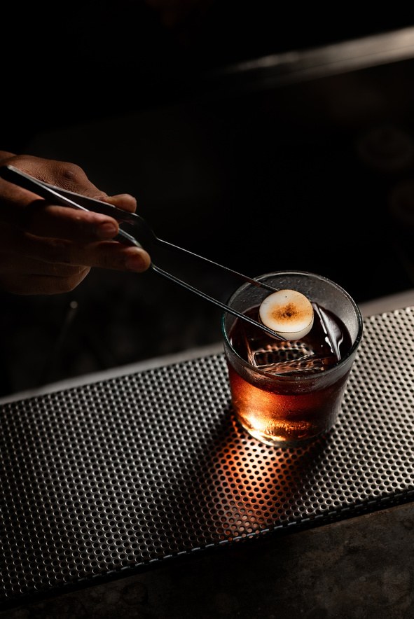 A cocktail finished with a smoked garnish